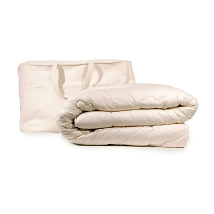 A beige Texeler Green Dream Wool Comforter made of organic cotton and wool, displayed in a folded state, isolated on a white background.