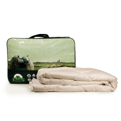 A beige Texeler Multi Choice comforter displayed in front of its packaging, which features an image of sheep on a green landscape. The comforter appears to be made of cotton and wool. 120 gram 