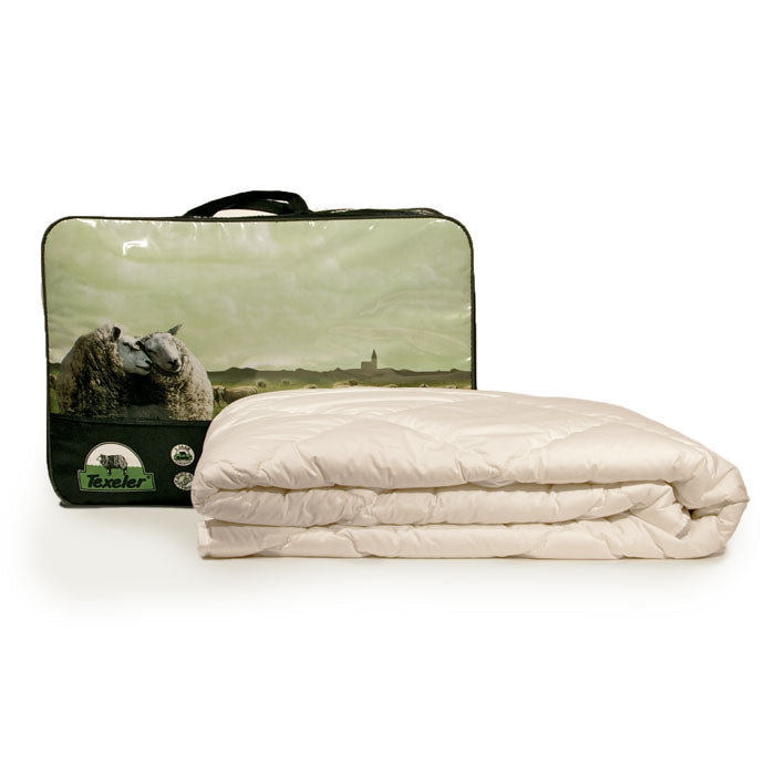 A beige Texeler Multi Choice comforter displayed in front of its packaging, which features an image of sheep on a green landscape. The comforter appears to be made of cotton and wool. 120 gram 