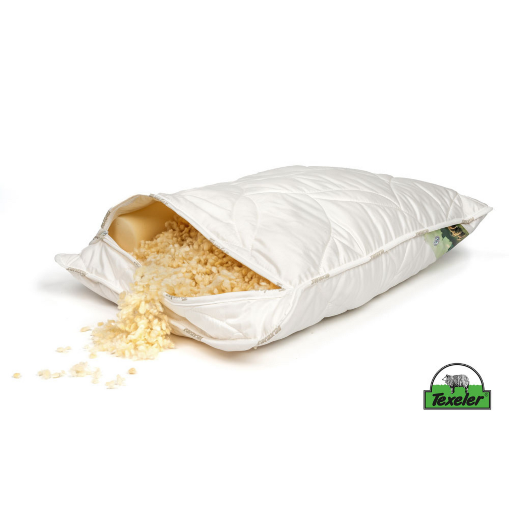 A white pillow with a textured design, featuring a small green and blue logo at the bottom corner. Texeler Soezz Perfection wool pillow with tencel cover. The zipper is undone to showcase the wool balls and additional necksupport