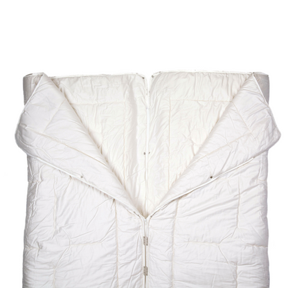 The texeler satin partner wool comforter laying flat while the zipper is undone in the middle to show the function of the comforter. Angle from above.