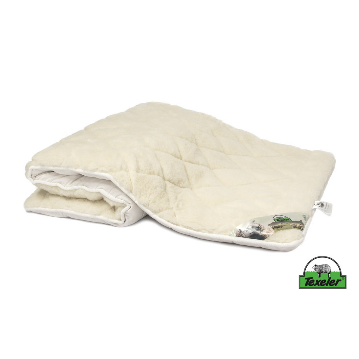 A beige mattress topper made of sheep wool with a wool and cashmere layer on top, placed on a white background, Laying half folded on the surface and the brand name texeler
