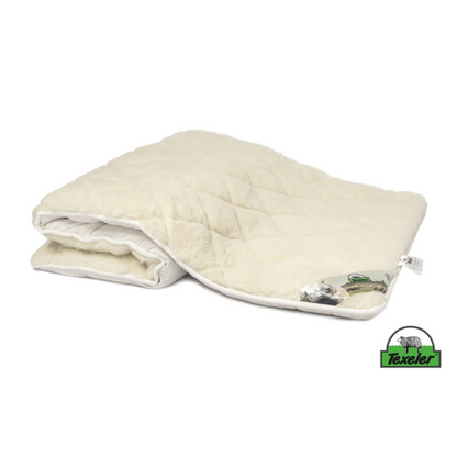 A beige mattress topper made of sheep wool with a wool and cashmere layer on top, placed on a white background, Laying half folded on the surface and the brand name texeler